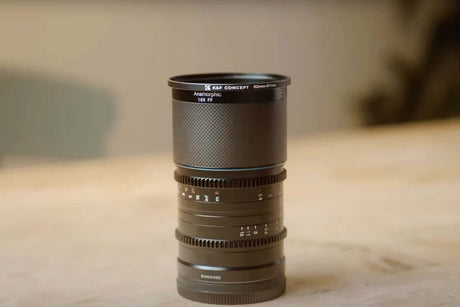 What is Macro Photography | Gear, Lighting & AI (Guide 2025) showing a close-up of a macro lens on a wooden surface.