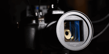 Close-up of Sirui 50mm anamorphic lens mounted on a camera, showcasing its unique design and features.