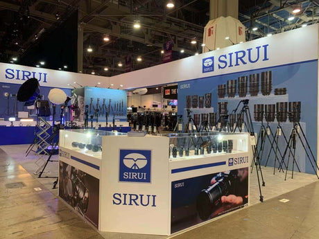 SIRUI booth at NAB 2023 showcasing cameras, tripods, and lighting equipment.