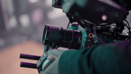 Close-up of a Sony camera with a Sirui 35mm anamorphic lens being operated in a filmmaking setup.
