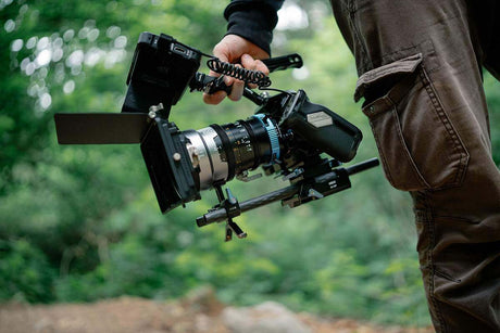 Buyer’s Pick | Mirrorless Interchangeable Lens Camera vs DSLR: close-up of a mirrorless camera being held outdoors