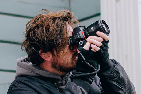 Photographer capturing stunning portrait shots with a DSLR camera in urban setting.