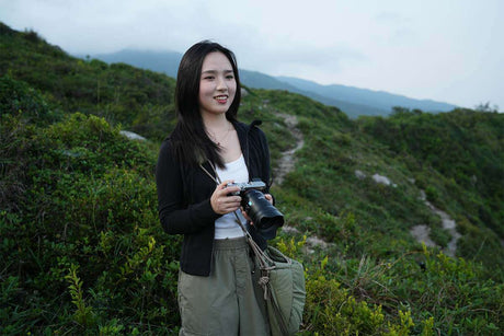 Ultimate Guide to Capturing a Photo with Background Blurred Effect: photographer smiling outdoors with a camera