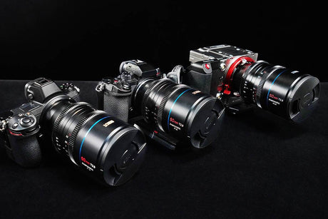 Three high-quality cameras with large lenses on a black background, showcasing options for shooting YouTube videos.