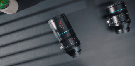 SIRUI 135mm T2.9 1.8x anamorphic lens on a table with shadow patterns, showcasing its design and features.