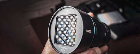 Close-up of an SRKUI anamorphic lens with detailed front element, emphasizing its design and structure.