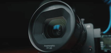 Close-up of a Sirui anamorphic lens showcasing its intricate design and glass elements.