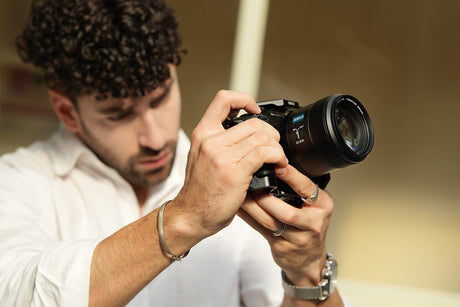 Person using a video camera, focusing on settings for optimal video blogging performance.